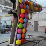 <p><strong>Coating: Nickel look, black soft-touch paint, smarties painted in multiple colors</strong><br />
Kata Legrady, Colt, 2013, 450x290x65 cm</p>
